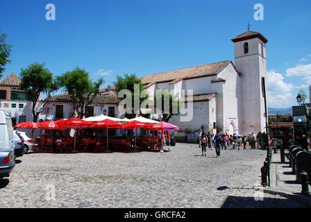 Straßencafé in der St. Nikolaus-Plaza mit Sankt-Nikolaus-Kirche auf der Rückseite im Stadtteil Albaicin, Granada, Spanien. Stockfoto