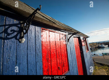 Rote und blaue Hütte im kleinen Fischerdorf Dorf von St. Abbs, Berwickshire schottischen Grenzen UK Stockfoto