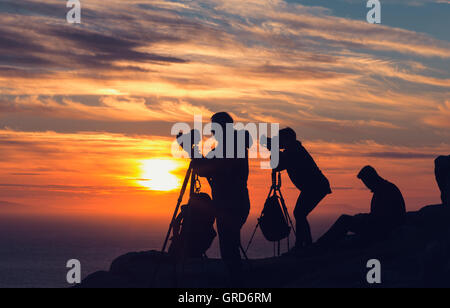 Eine Gruppe von Fotografen auf der Klippe Sonnenuntergang fotografieren Stockfoto