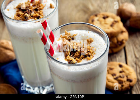 Hausgemachter Milchshake mit Schokolade-chips Cookies und Nüssen auf rustikalen Holztisch hautnah Stockfoto