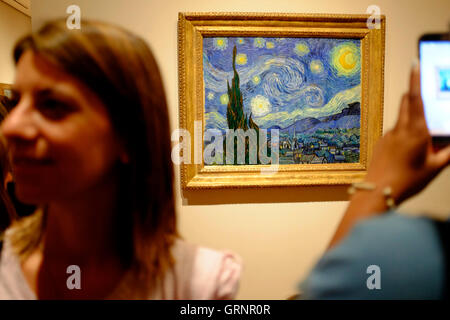 Besucher die Fotos von "Sternennacht" von Vincent Van Gogh im Museum of Modern Art (MoMA). Manhattan, New York City, USA Stockfoto