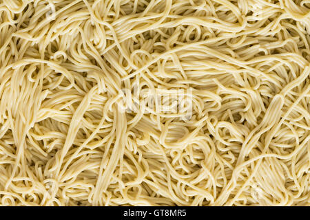 Italienische Spaghetti Nudeln Hintergrundtextur mit einem wirre Muster von gekochten plain Nudeln angesehen Vollformat Nahaufnahme von overhe Stockfoto