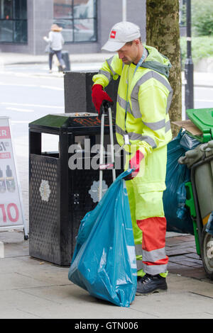 Ein "BIffa" Müllabfuhr Arbeiter aufräumen Müll in Manchester City centre Stockfoto