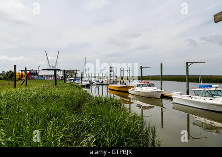 Garnelen, Fischen und Tour Boote auf einem Fluss durch ein Salz Wasser Sumpf zwischen Savanne und Tybee Island, Georgia Stockfoto