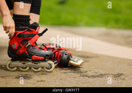 Mädchen trägt Rollschuhe auf Straße Stockfoto