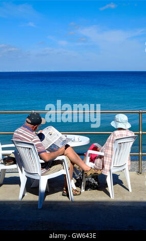Seniorenpaar sitzt auf der Promenade in sheringham, norfolk, england Stockfoto