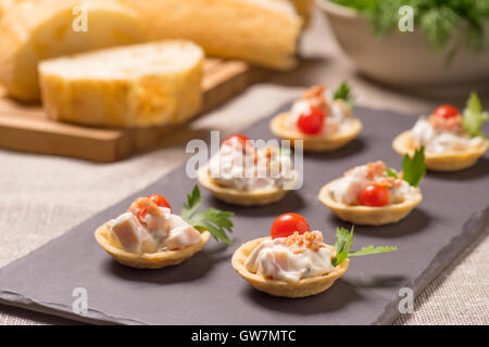 Kanapees, Vorspeise mit cremig-Hähnchen-Salat auf dem Schiefer Silbertablett serviert Stockfoto