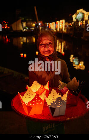 Ältere Frau Verkauf schwimmende Kerze Laternen, Hoi an ein (UNESCO Weltkulturerbe), Vietnam Stockfoto
