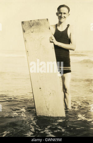 Anfang des zwanzigsten Jahrhunderts Foto des Mannes mit hölzernen Surfbrett. Stockfoto