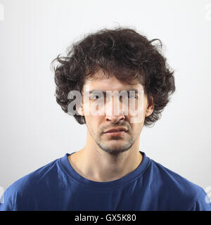 Zorniger junger Mann im blauen Hemd Portrait. Stockfoto