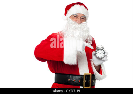 Santa zeigt auf eine antike Zeitmesser Stockfoto