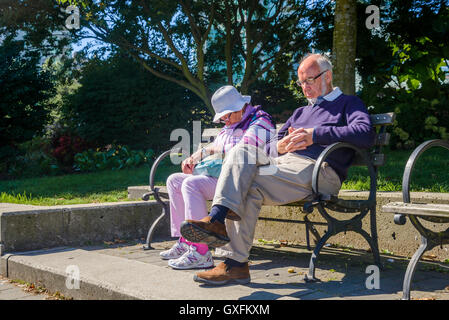 Älteres Ehepaar schlief auf Parkbank Stockfoto