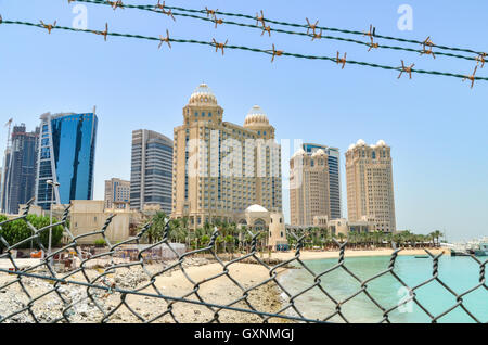 Zäune und Stacheldraht vor den Hochhäusern von Doha, Katar Stockfoto