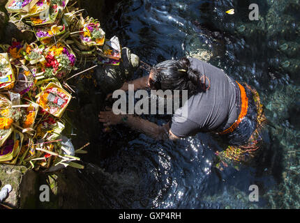 Tampak Zeugung, Bali, Indonesien, 10. September 2016: eine Frau, die sich zu waschen unter fließendem Wasser reinigen Stockfoto