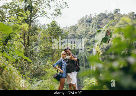 Junge Touristen nehmen Selfie im Wald. Mann und Frau im Wald unter Selbstbildnis mit ihrem Handy. Stockfoto