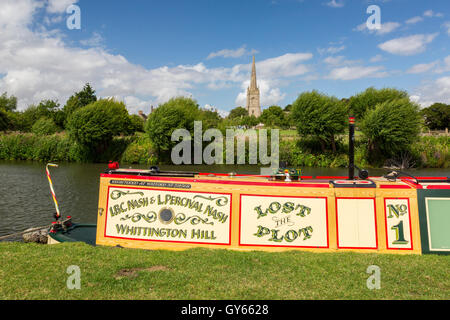 Eine schmale Boot vertäut an der Themse gegenüber der Pfarrkirche St Lawrence bei Lechlade, Gloucestershire, England, UK Stockfoto