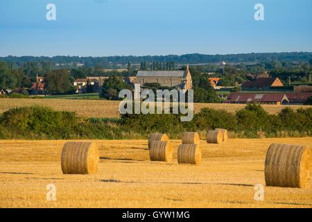 Rundballen mit Binham Priory und Binham Dorf in Ferne, Norfolk, England. Stockfoto