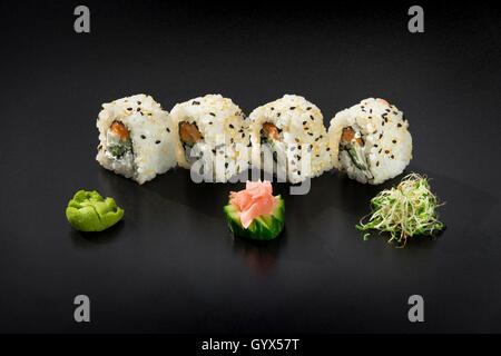 Uramaki Maki Sushi auf schwarzem Hintergrund Stockfoto