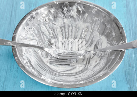 Schmutzige Silberschale nach Quark Frühstück mit Gabeln auf rustikalen Holztisch. Stockfoto