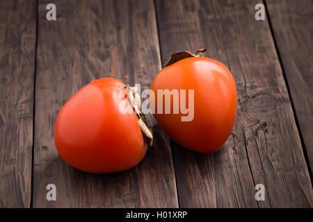 Zwei Reife orange Persimmon auf Tisch Stockfoto