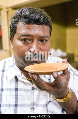 MUMBAI, Indien - 5. Februar 2015: Porträt der indischen Mann Milchtee trinken im traditionellen Stil. Trinken heißen Tee aus Untertasse ma Stockfoto