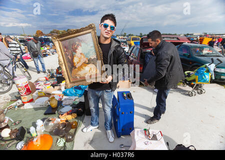 ZAGREB, Kroatien - 20. Oktober 2013: Roma Verkäufer halten verwendet altes Bild und Lautsprecher auf Zagrebs Flohmarkt Hrelic. Stockfoto