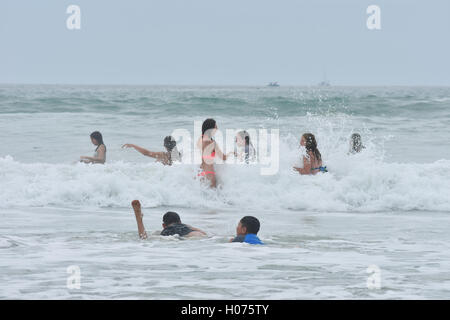 Junge Menschen in Badeanzügen ozeanischen Surf Wellen genießen Stockfoto