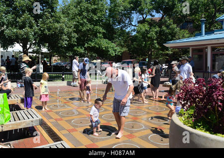 Vater und Sohn spielen bei der Kinder-Wasser-Funktion auf Pearl Street Mall Stockfoto