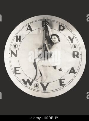 Frau sitzt auf riesigen Happy New Year-Uhr Stockfoto