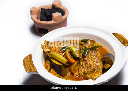 Curry von Fischkopf mit Auberginen und traditionellen Holzkohlegrill auf weißem Hintergrund Stockfoto