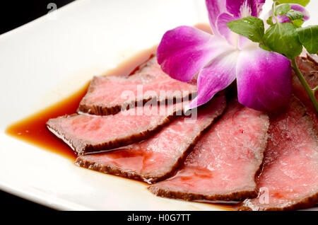 Frisch gebratenes Rindfleisch auf weißen Teller mit Kräutern im restaurant Stockfoto