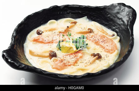 Japanische Udon-Nudeln mit Lachs, Champignons, Zitrone und sprießen in schwarz Schüssel Stockfoto