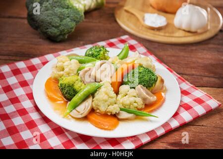 Teller mit gebratenen Gemüse mit Blumenkohl, Pilze, Karotten und grünen Bohnen auf dem Tisch im restaurant Stockfoto