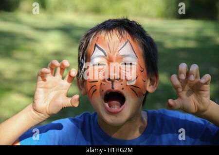 Kleiner Junge mit lustigen Kinderschminken als tiger Stockfoto