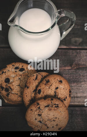Milch in die Glaskanne und hausgemachten Schokoladenkekse Stockfoto