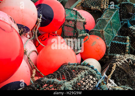 Eine verwirrte Heap der hellen orange/rot Angeln schwebt und Reusen Stockfoto