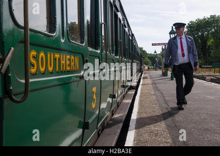 Der Dirigent zu Fuß auf der Plattform in Havenstreet auf der Isle Of Wight Steam Railway Stockfoto