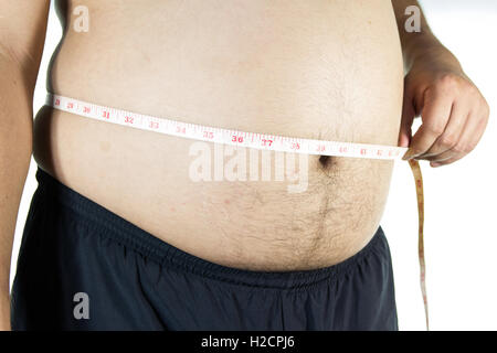 Dicker Mann hält ein Maßband Stockfoto