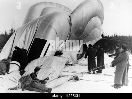 Das Bild der Nazi-Propaganda zeigt Soldaten der deutschen Wehrmacht, die einen gefangenen Ballon zum Zweck der Luftbeobachtung aufblasen. Das Foto wurde im März 1943 veröffentlicht. Die Bildunterschrift auf der Rückseite des Fotos vom 18. März 1943 schreibt: "Der Ballon der B-Abteilung ist aufgeblasen. Langsam tritt das Gas in den großen Körper ein. Die Soldaten ballastieren die Hülle, damit das Gas durchgehend eindringen kann." Fotoarchiv für Zeitgeschichte - KEIN KABELDIENST - | weltweite Nutzung Stockfoto