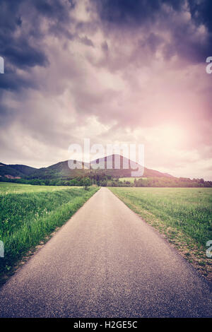Vintage toned countryside road at sunset. Stockfoto