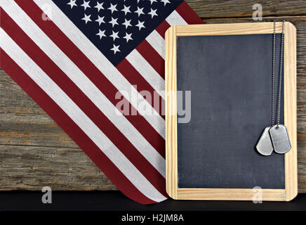 militärische Erkennungsmarken an schwarze Tafel mit amerikanischen Flagge Stockfoto