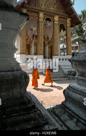 Mönche, die zu Fuß durch Tempel in Luang Prabang Laos Stockfoto