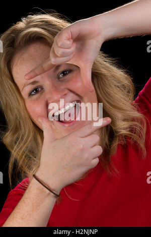 Close-up on a woman framing her face with her fingers Stockfoto