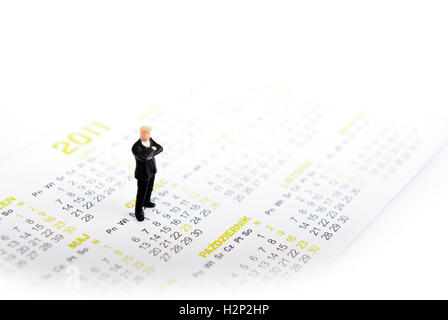 Miniatur-Mann im Kalendar stehen Stockfoto