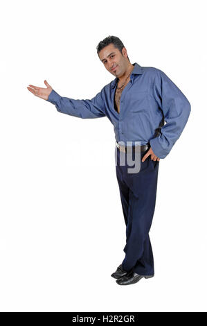 Ein großer junger Mann in ein blaues Hemd und Hosen stehen für weißen Hintergrund als Wegweiser mit eine nette Geste. Stockfoto