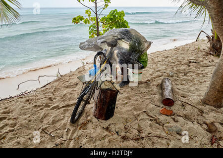 Barbados Fischer enthäuten Fahrrad Hastings beach Hotel Savannah einheimischen Fischer arbeiten unter Tar Schlackenlinie Blatt Zyklus Fisch Sand Stockfoto