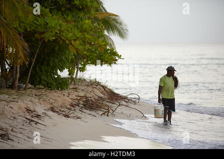 Barbados Fischer enthäuten Motorrad, das Hastings Strand Hotel Savannah einheimischen Fischer arbeiten Fisch Sand Bäume net Palmblätter hand ich Stockfoto