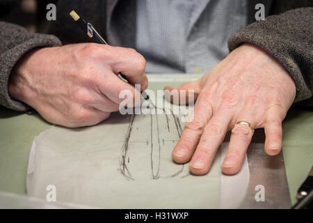 Die Hand eines Mannes zeichnen eine Skizze auf Transparentpapier. Stockfoto