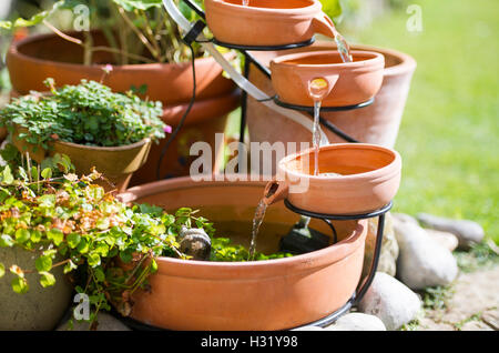 Ein Terrakotta-Wasserspiel mit Solarstrom im Garten UK Stockfoto