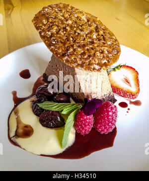 Mousse au Chocolat auf Espresso Schwamm mit Rotwein gewürzt Kirschen als Dessert auf Hinterhof Hof im Okanagan Valley, Kanada Stockfoto